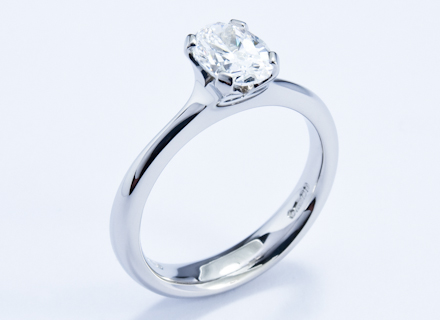 Four claw platinum ring with an oval brilliant cut diamond
