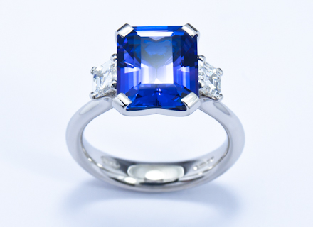 Four claw three stone platinum ring with emerald cut tanzanite and asscher cut diamonds