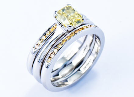 Four claw platinum ring with a natural yellow diamond