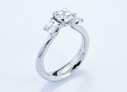 Four claw three stone platinum ring with asscher cut diamonds