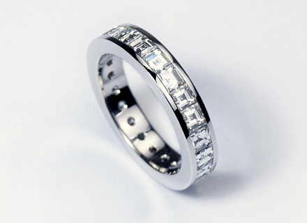Eternity style platinum ring channel set with carre cut diamonds