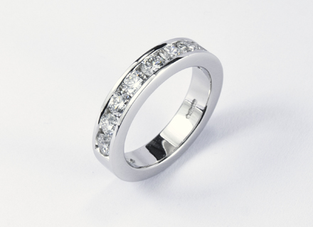 Eternity style platinum ring channel-set with round Brilliant cut diamonds