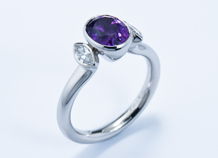 Rub over three stone platinum ring with purple sapphire and diamonds