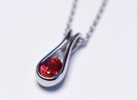 Oval cut ruby and platinum pendant