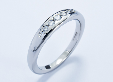 Eternity style ring channel set with graduated round brilliant cut diamonds